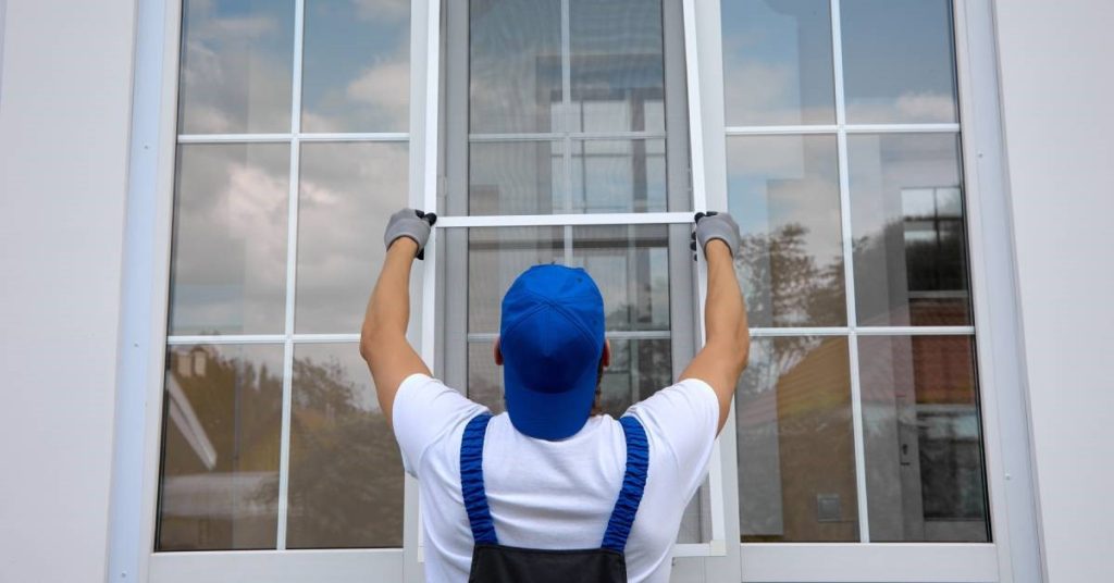 A professional contractor places the finishing touches on his newly installed windows for his residential client.