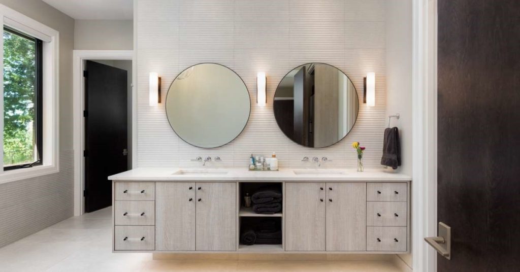 A modern and luxurious home bathroom with various types of effective lighting designs, including task and ambient lighting.