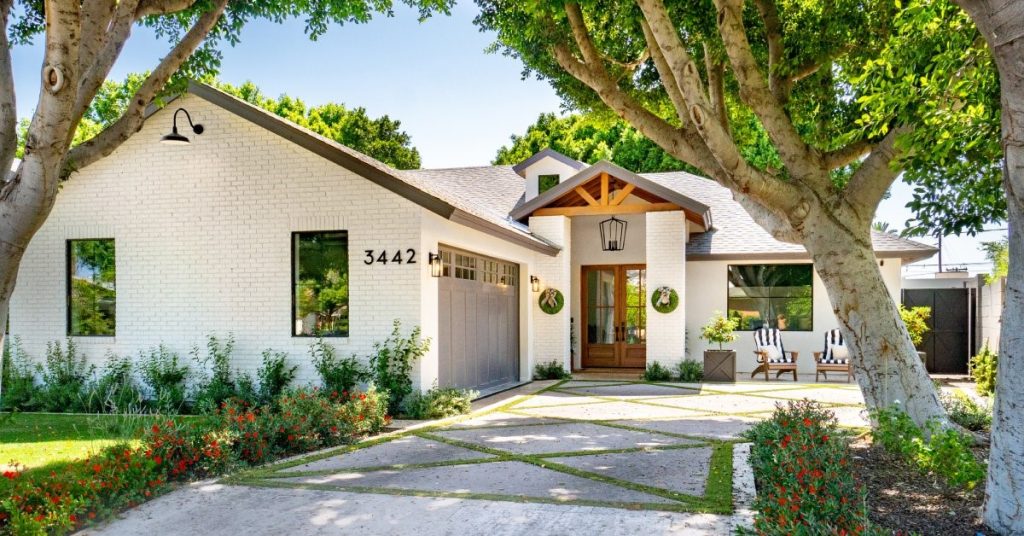 The front entrance of a ranch-style home. Modern landscaping and windows contribute to the home's aesthetics.